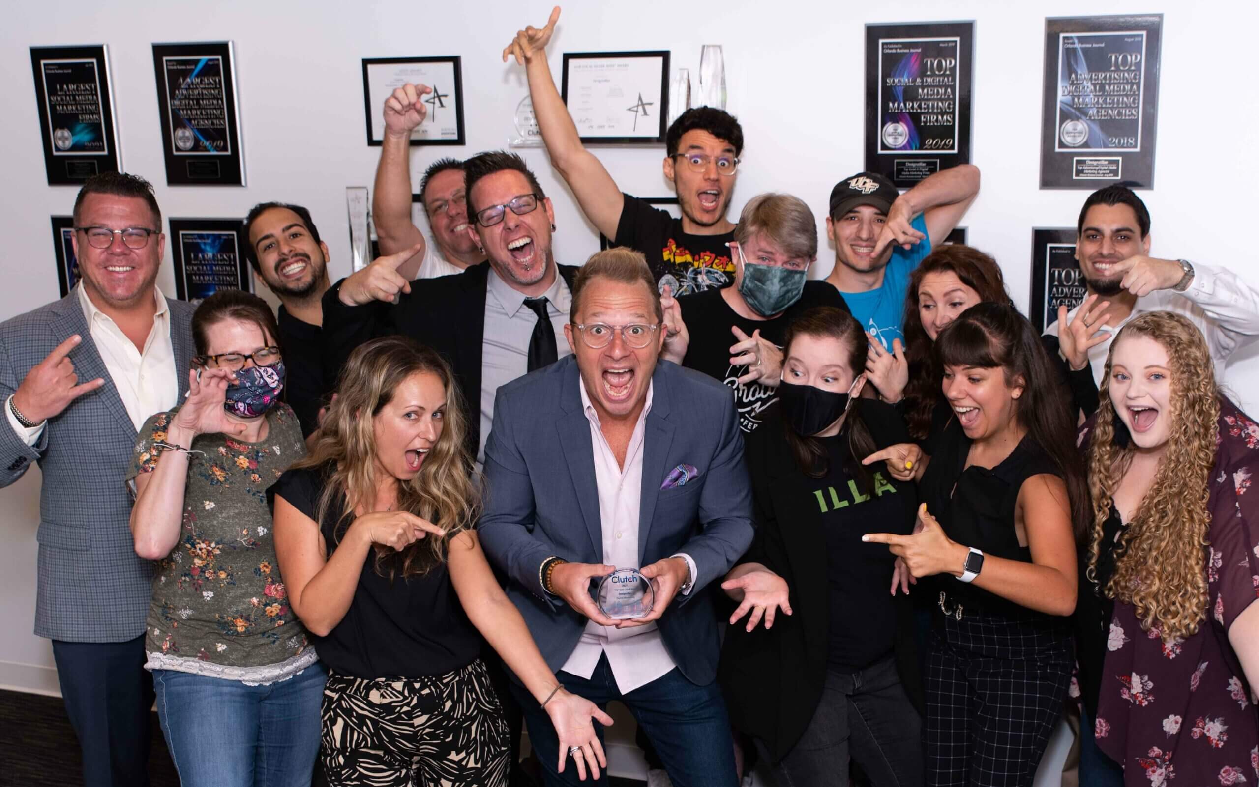 Designzillas Group Shot With Clutch Trophy for Top Advertising & Marketing Agency