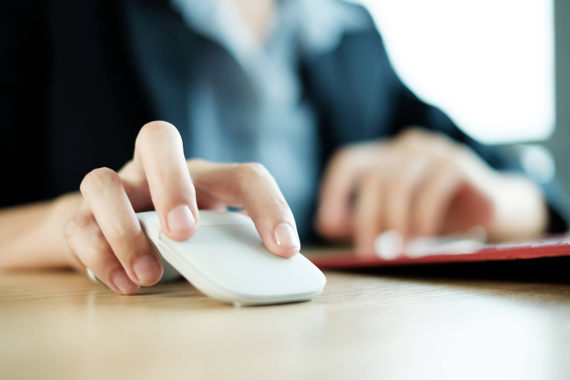 Woman clicking a computer mouse