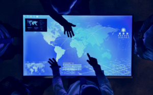 Individuals interacting with a digital map of the world for cybersecurity