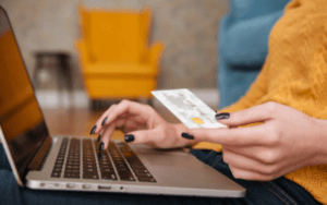 Closeup of online shopper's hands holding credit card