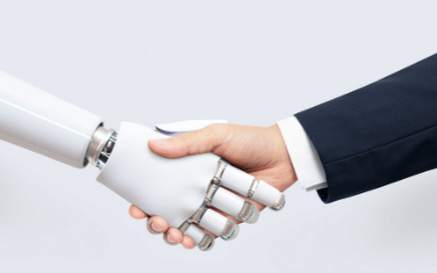 A human hand shaking the "hand" of an AI machine.