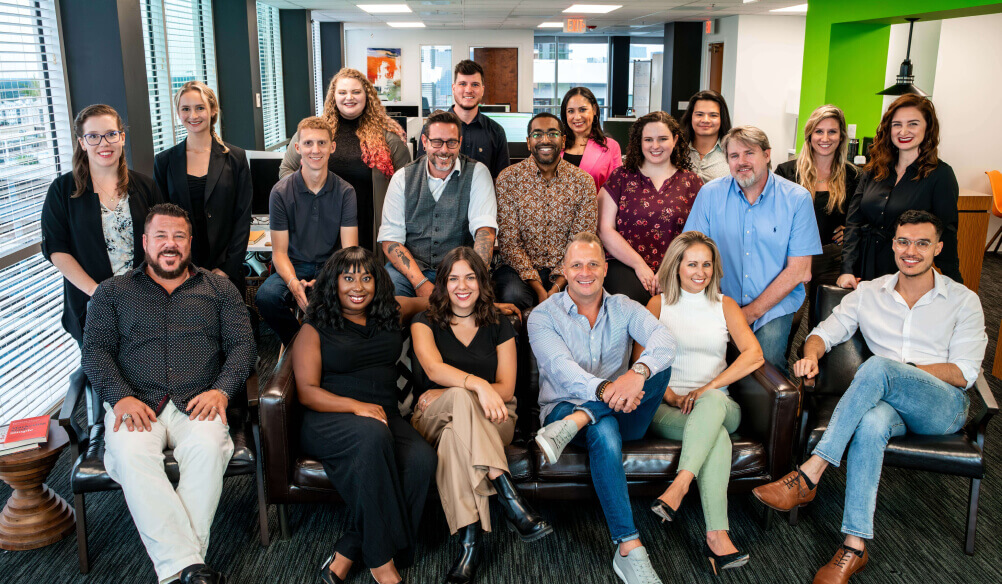 A group of employees smiling for a picture