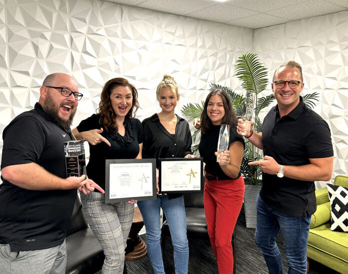 A group of people holding awards